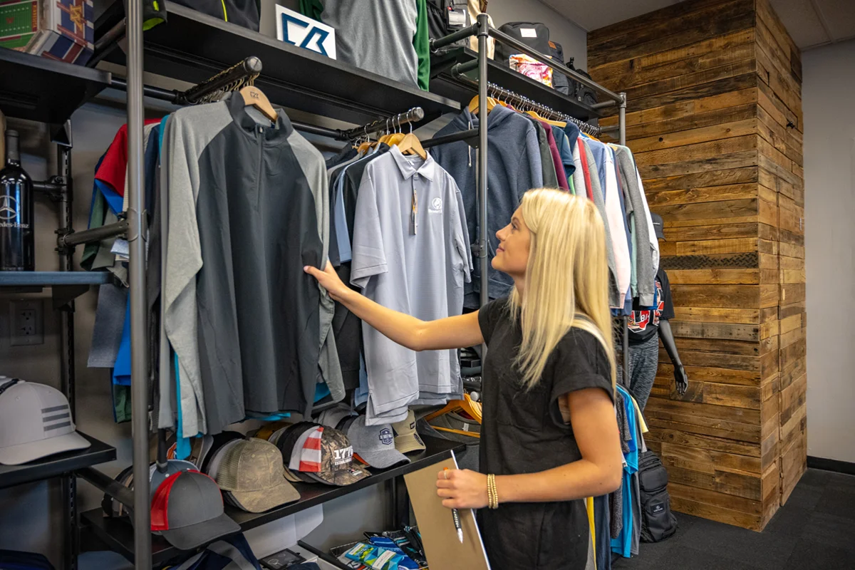 Woman feeling apparel products in showroom
